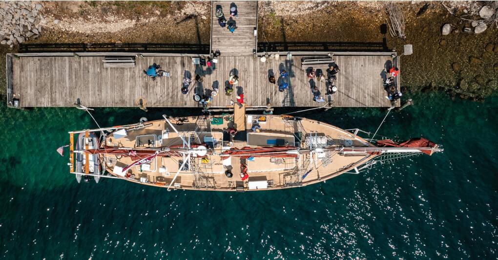 A birds-eye view of the school schooner and dock, being loaded with people